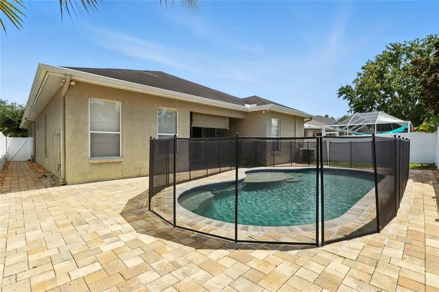 a view of a house with a backyard