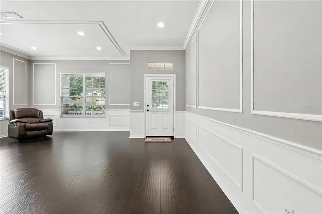 a view of a livingroom with wooden floor and a large window