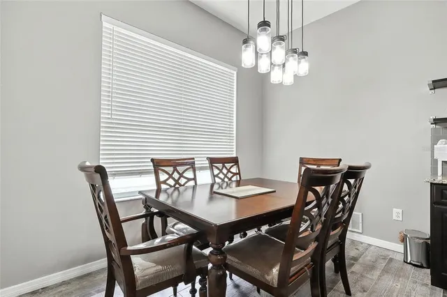 a view of a dining room with furniture and chandelier