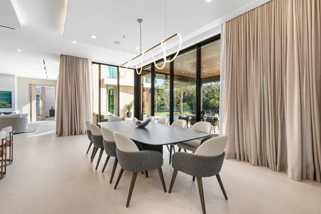 a view of a house with swimming pool and sitting area