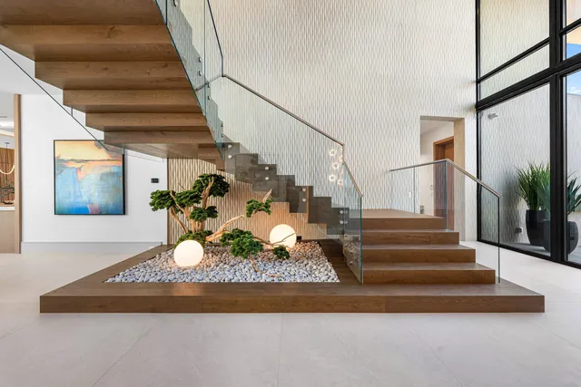 a spacious bedroom with a bed and wooden floor