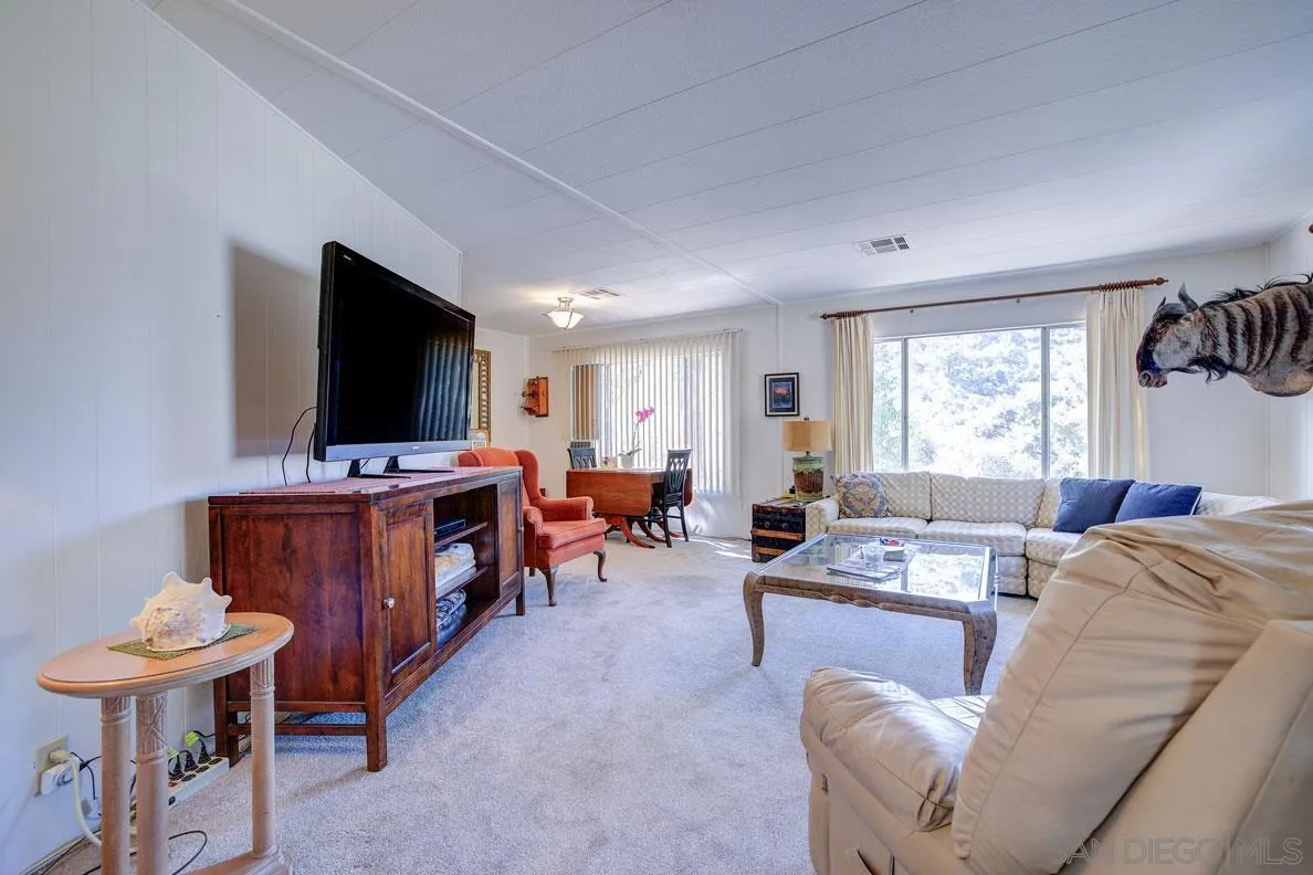 31050 Lilac Road Valley Center, CA 92082 - Photo 8 of 35 a living room with furniture and a flat screen tv
