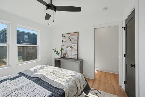 a bedroom with a bed dresser and a window