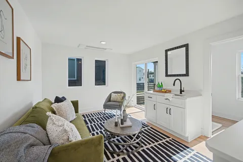 a living room with furniture and wooden floor