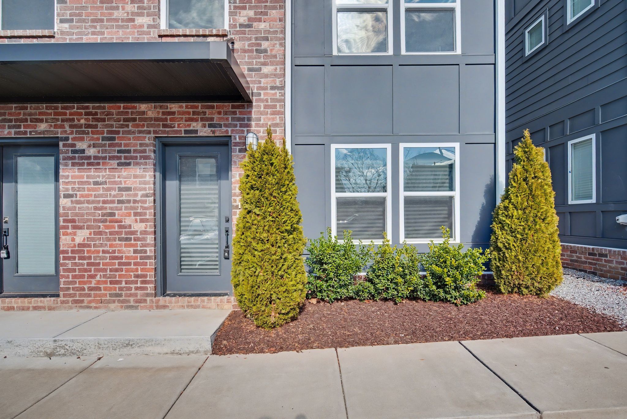 102 Duke Street, Unit 7 Nashville, TN 37207 - Photo 23 of 25 a front view of a house with a yard and plants