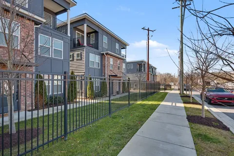 a view of a street with brick building in the background