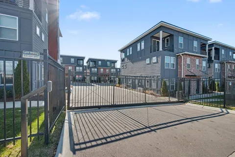 a view of a brick house with wooden fence