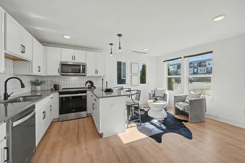 a kitchen with sink a stove and cabinets