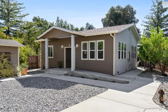 a view of a house with a yard and plants