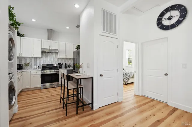 a kitchen with stainless steel appliances granite countertop a stove a sink and a refrigerator