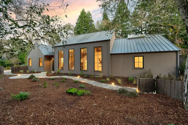a backyard of a house with barbeque oven table and chairs