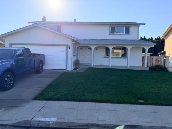 a front view of a house with a garden and yard