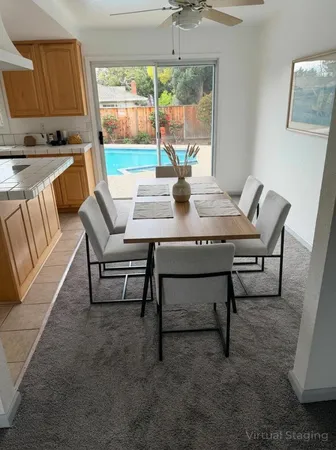 a dining room with furniture a window and a rug