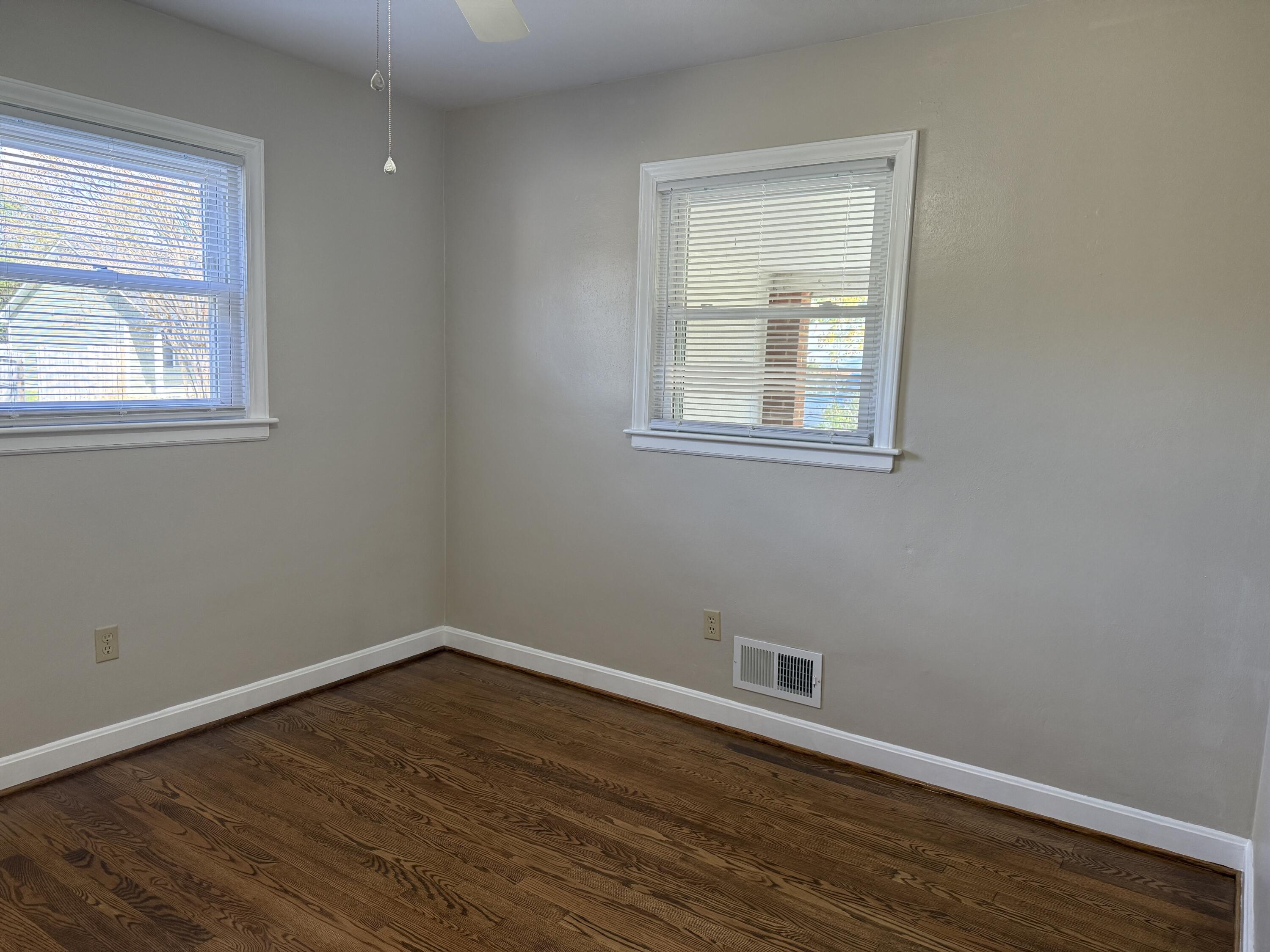 222 Ross Street Salem, VA 24153 - Photo 11 of 20 a view of an empty room with wooden floor and a window