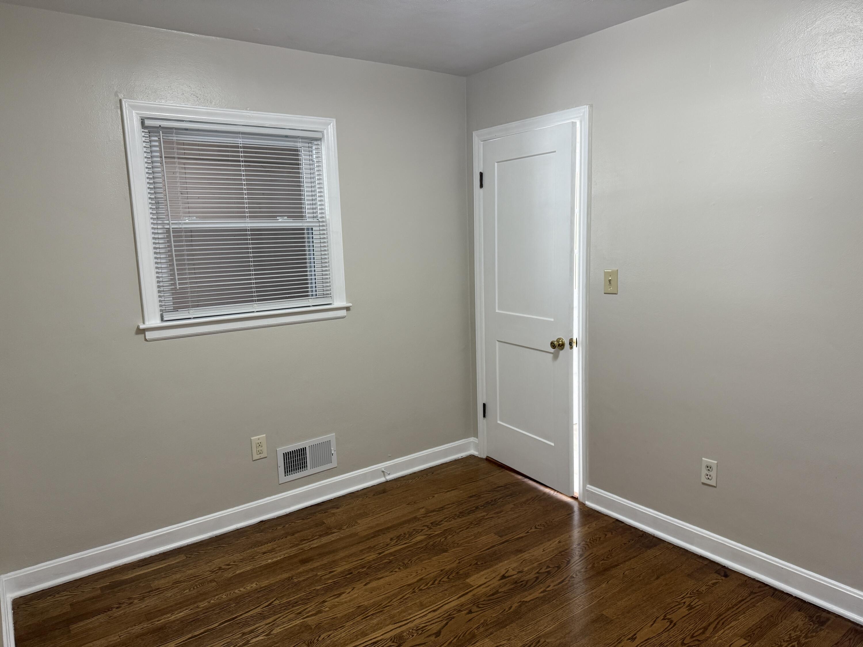 222 Ross Street Salem, VA 24153 - Photo 13 of 20 a view of an empty room with wooden floor and a window