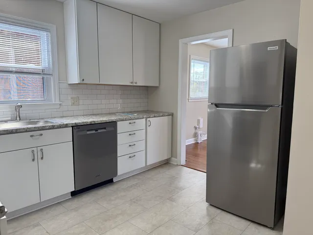 a white refrigerator freezer sitting inside of a kitchen