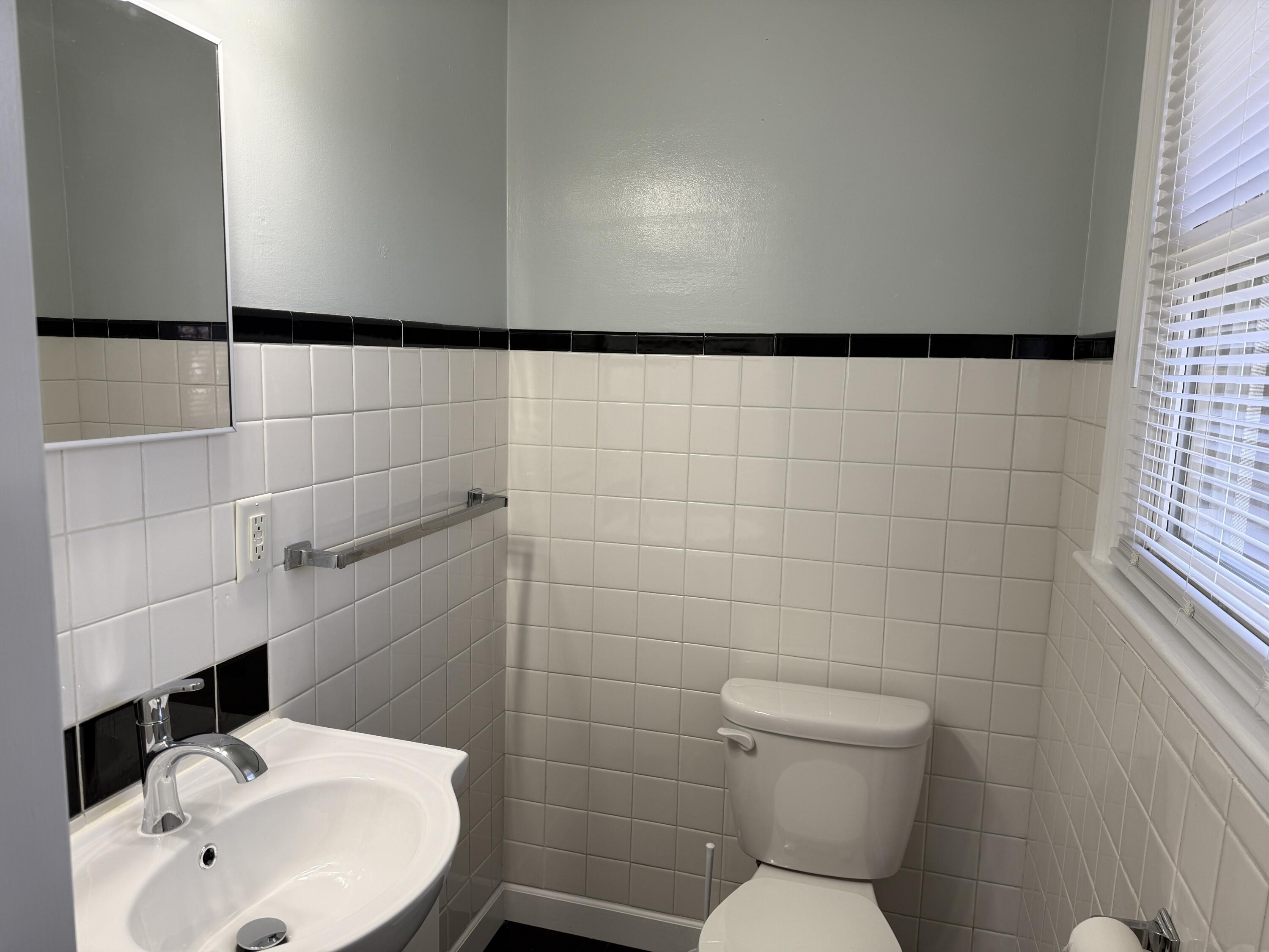 222 Ross Street Salem, VA 24153 - Photo 6 of 20 a bathroom with a sink a toilet and a mirror