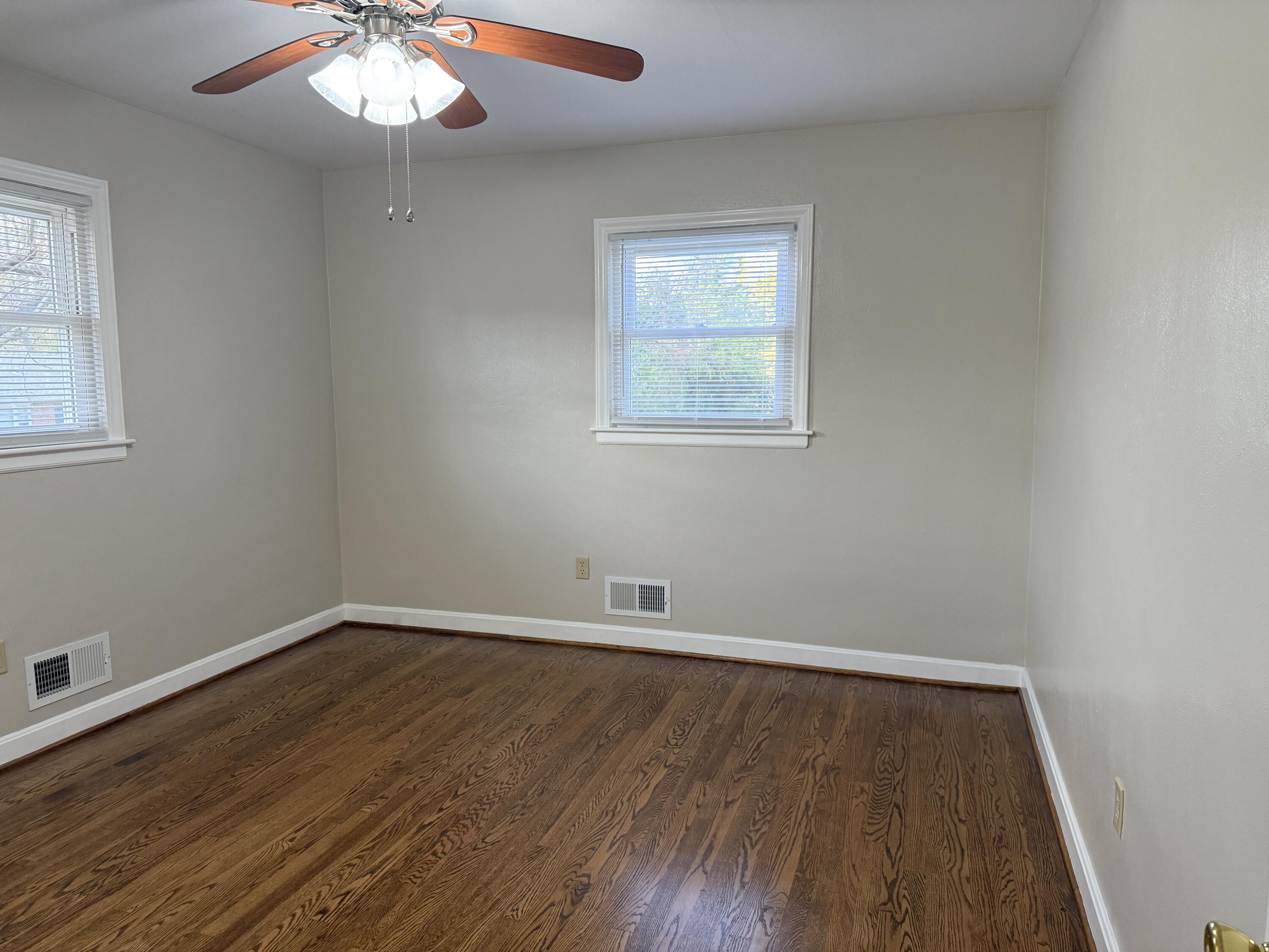 222 Ross Street Salem, VA 24153 - Photo 9 of 20 an empty room with wooden floor and windows