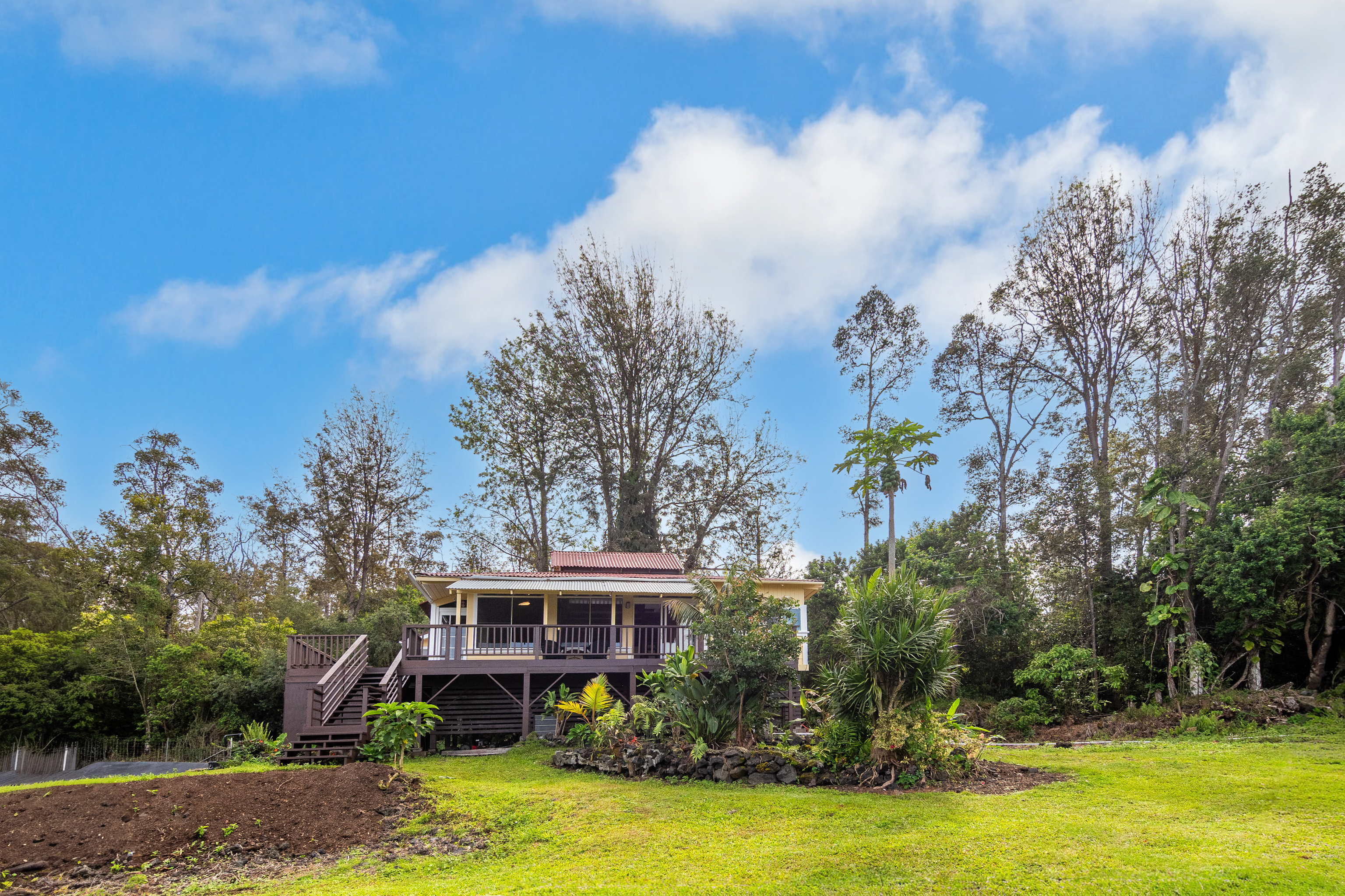 89-1426 Hawaii Belt Road Captain Cook, HI 96704 - Photo 1 of 30 a view of a house with swimming pool and a yard