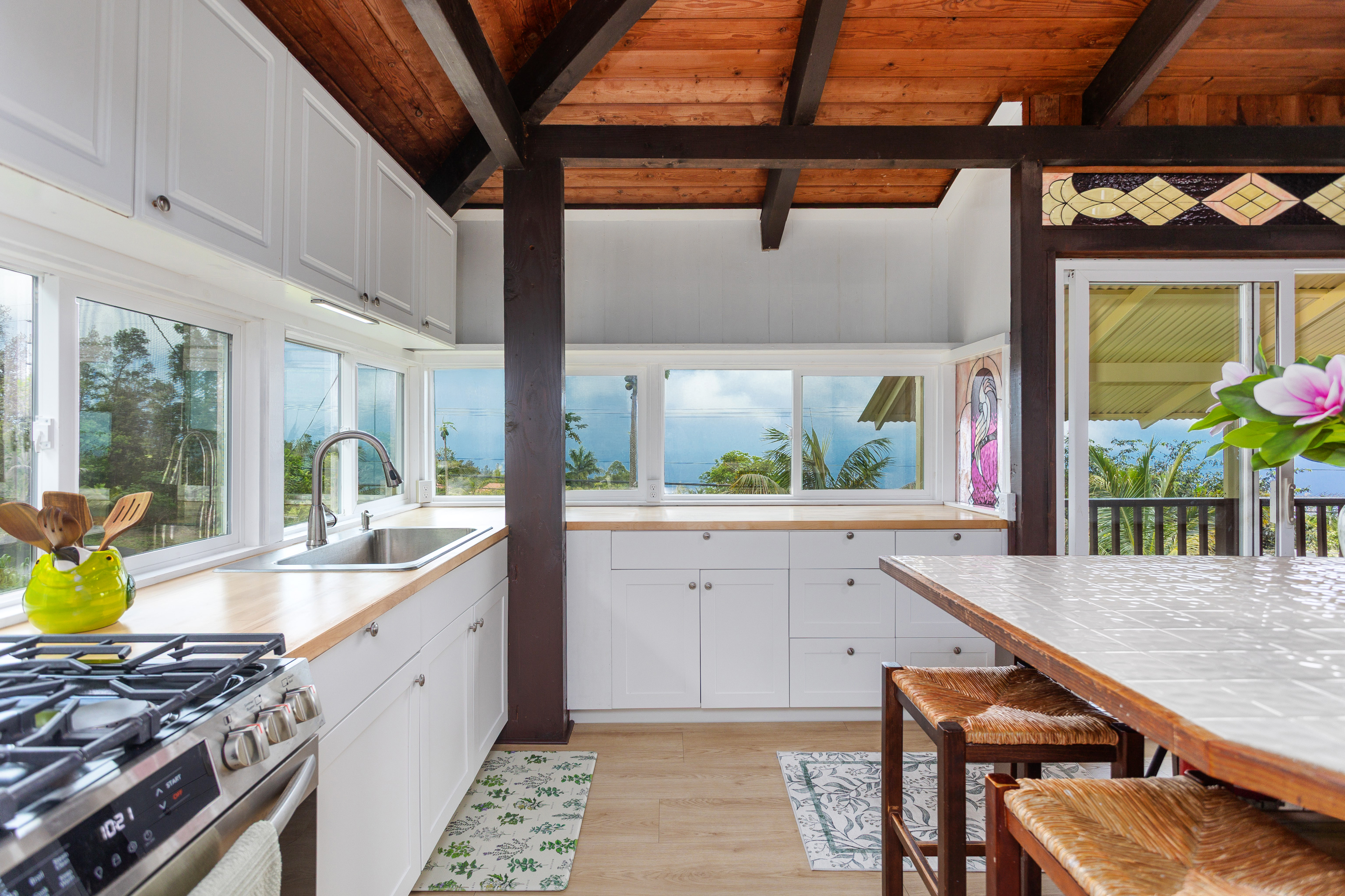 89-1426 Hawaii Belt Road Captain Cook, HI 96704 - Photo 11 of 30 a kitchen with a stove a sink and a wooden floors