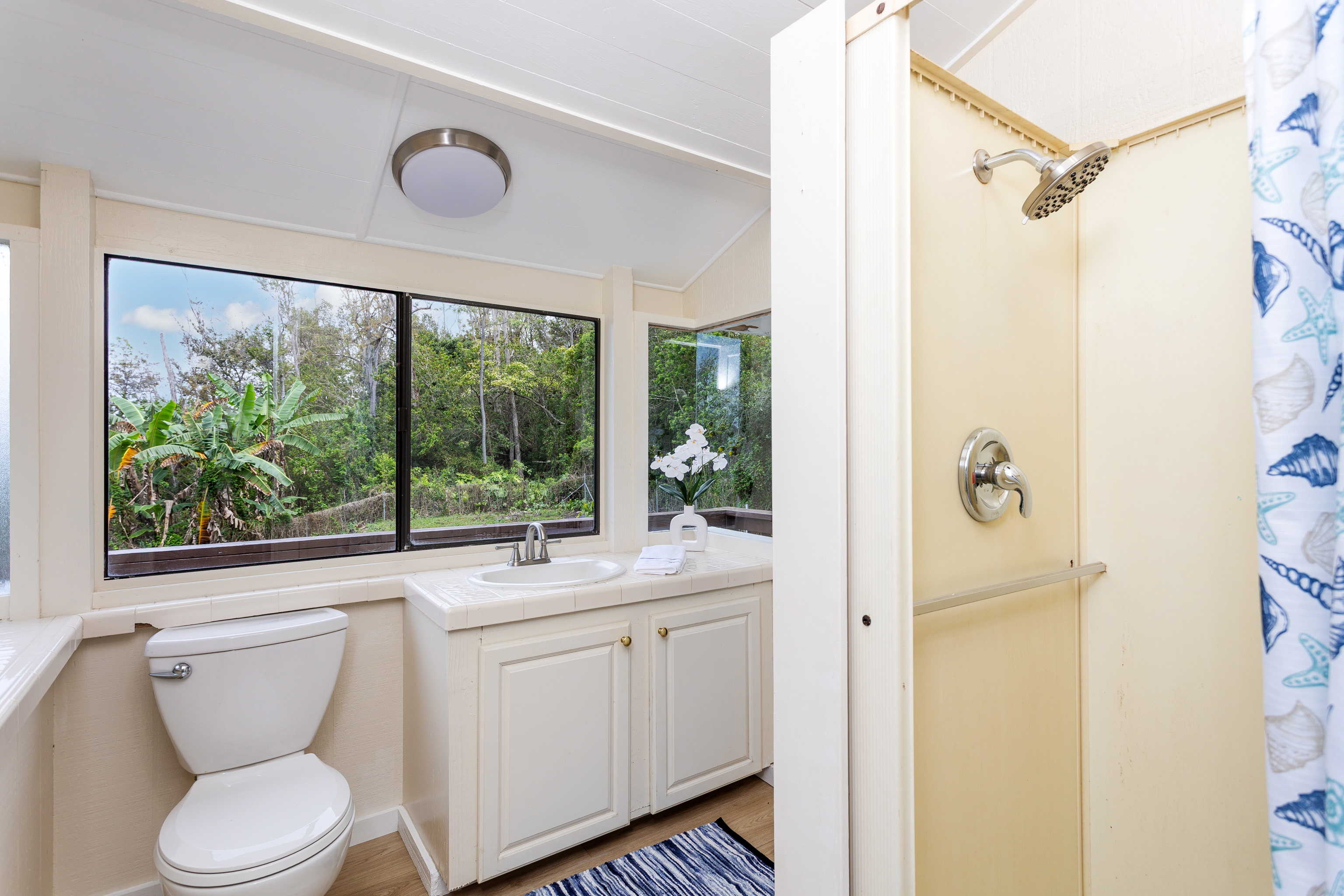 89-1426 Hawaii Belt Road Captain Cook, HI 96704 - Photo 17 of 30 a bathroom with a granite countertop sink toilet and shower