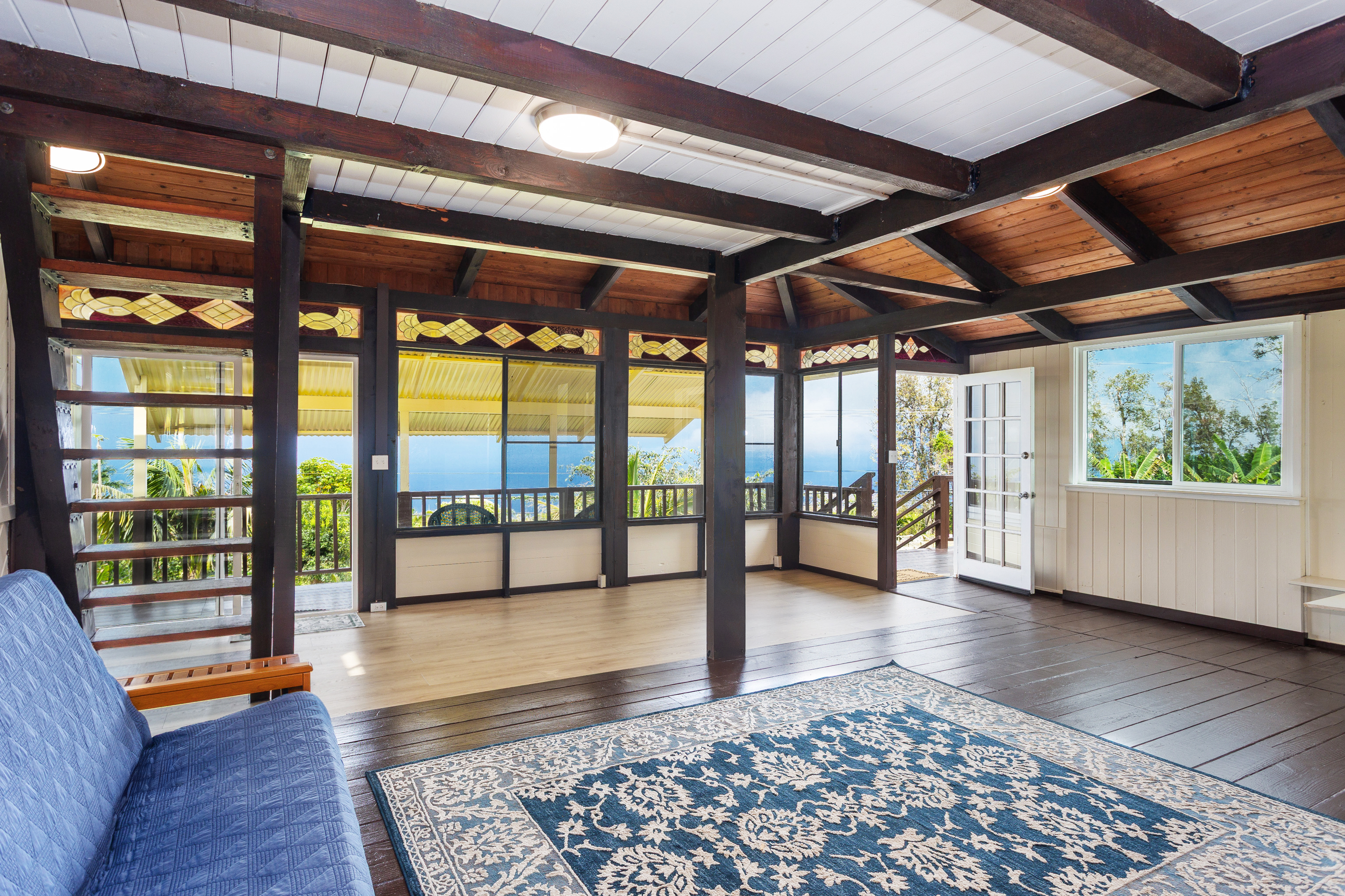 89-1426 Hawaii Belt Road Captain Cook, HI 96704 - Photo 7 of 30 a view of an empty room with wooden floor and a window