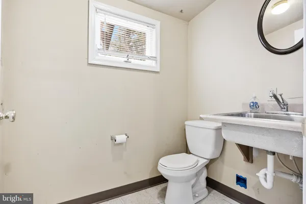 a living room with furniture a flat screen tv and kitchen view