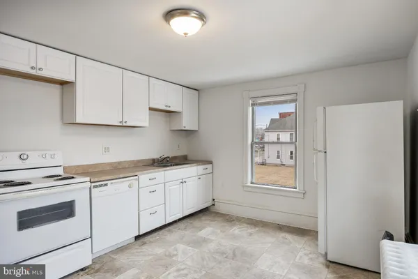 a view of a kitchen with a sink and a window