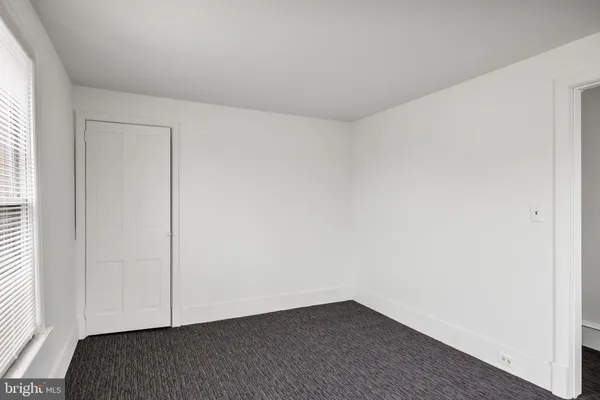 a view of a big room with windows and chandelier fan