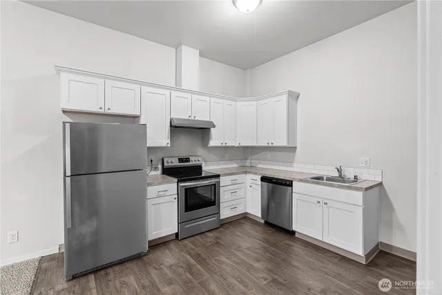 a kitchen with a white cabinets and white appliances