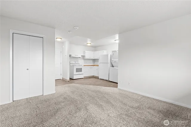 a view of a kitchen with a sink and refrigerator