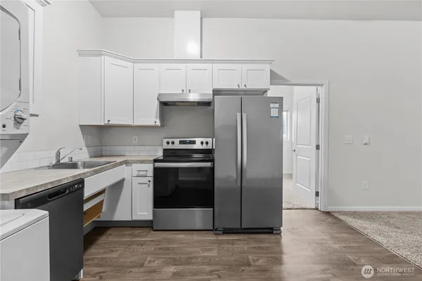 a kitchen with stainless steel appliances a refrigerator sink and stove
