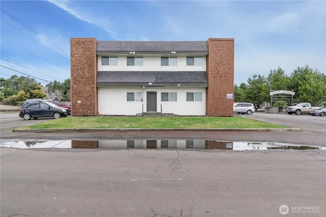 a front view of a house with a yard and a garage