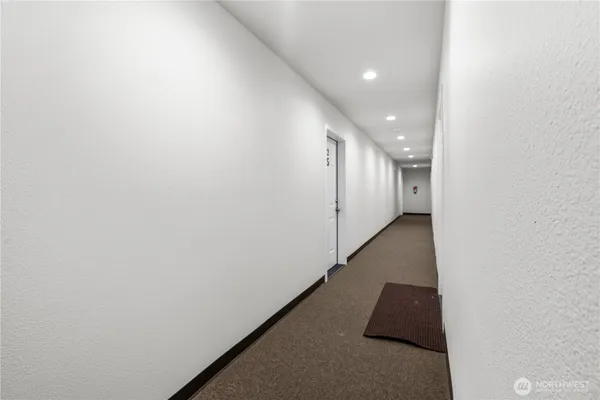 a view of a hallway with stairs