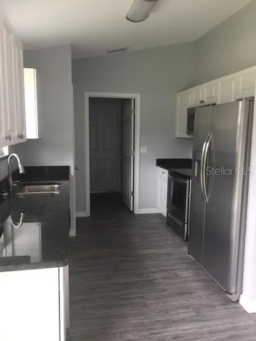 a kitchen with a refrigerator and a sink