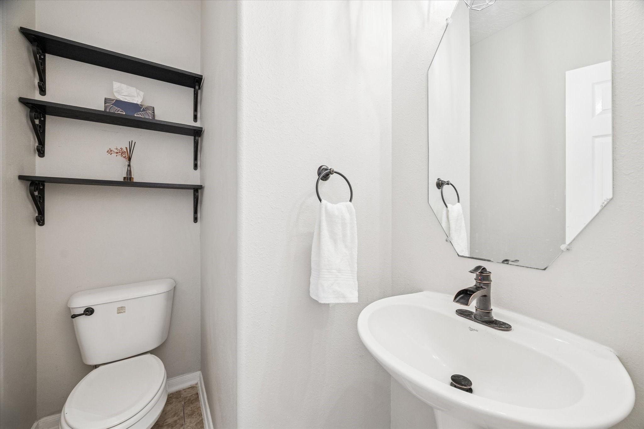 7243 Emerald Run Lane Spring, TX 77379 - Photo 17 of 35 a bathroom with a toilet sink and mirror