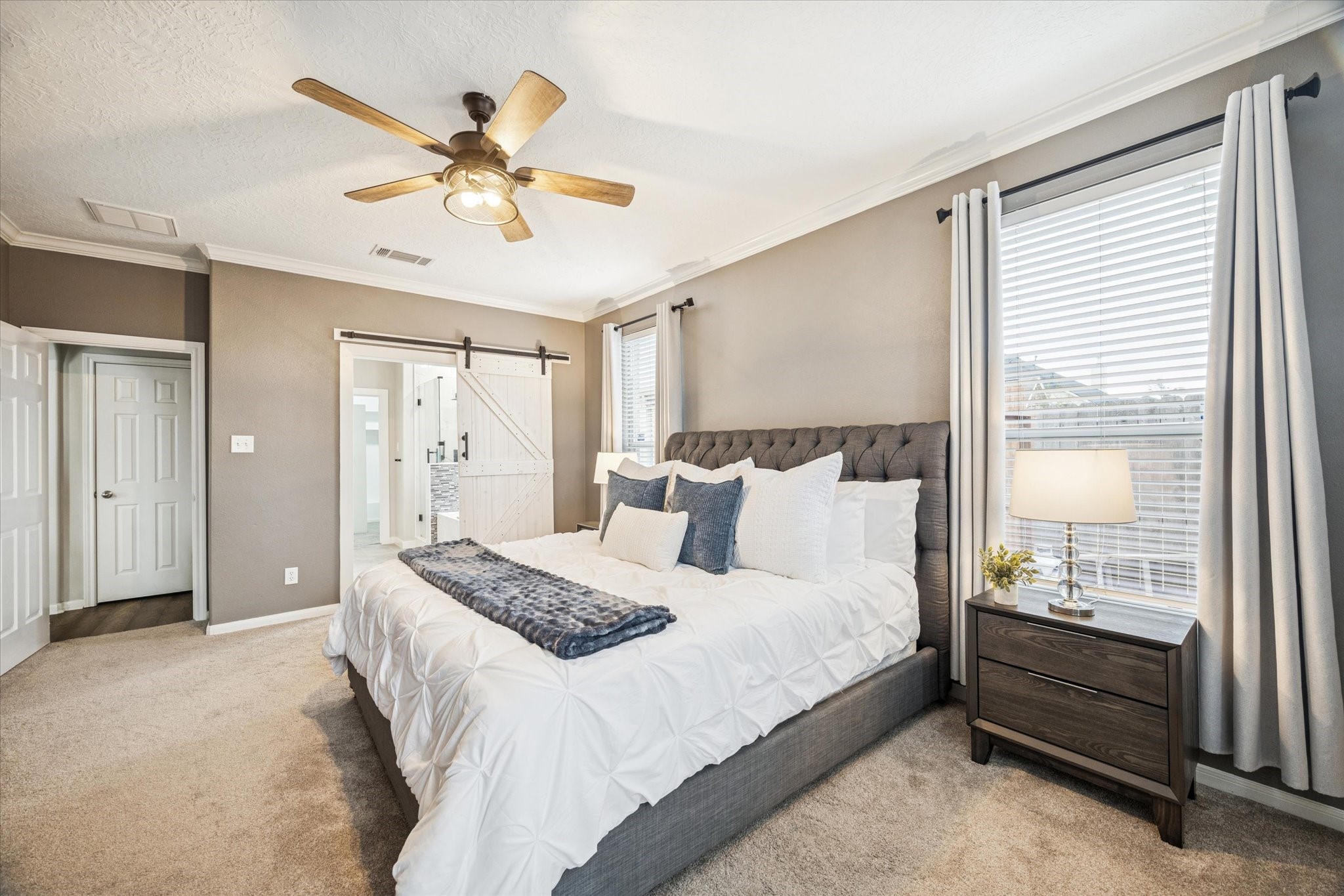 7243 Emerald Run Lane Spring, TX 77379 - Photo 19 of 35 a bedroom with a large bed and a chandelier fan