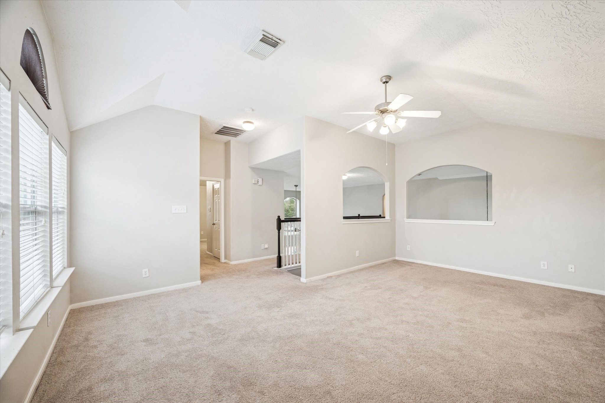 7243 Emerald Run Lane Spring, TX 77379 - Photo 24 of 35 an empty room with chandelier fan and windows