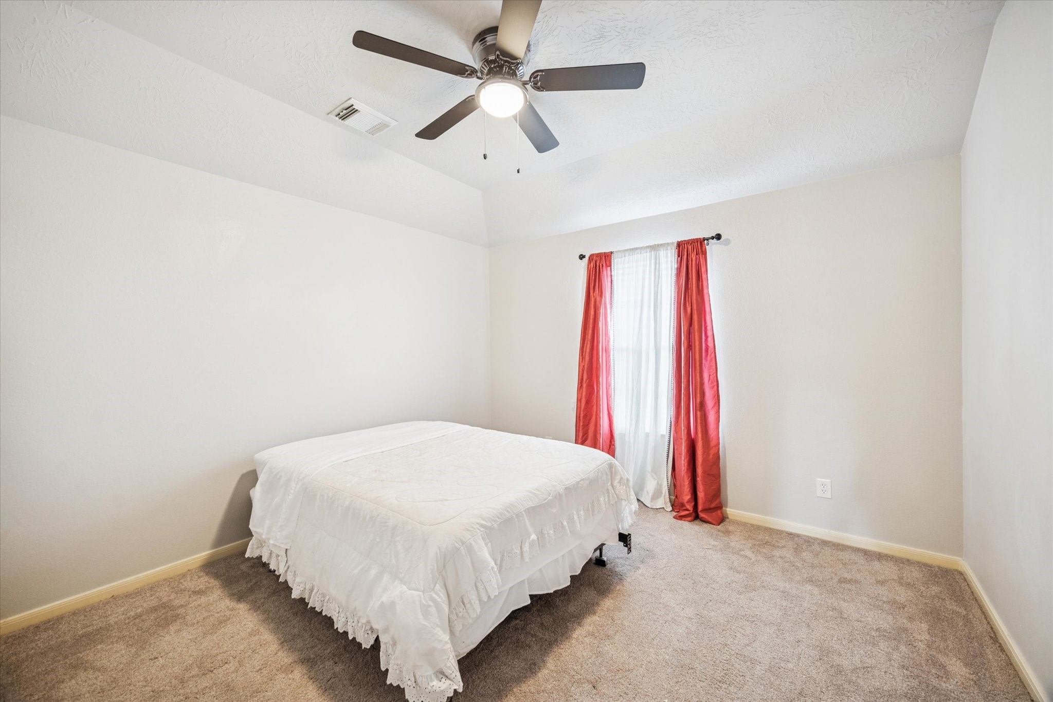 7243 Emerald Run Lane Spring, TX 77379 - Photo 26 of 35 a bedroom with a bed and a chandelier