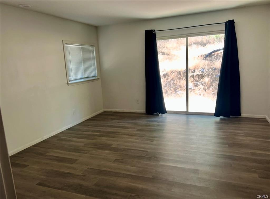 3568 Manzanita Road Mariposa, CA 95338 - Photo 11 of 17 a view of an empty room with wooden floor and a window