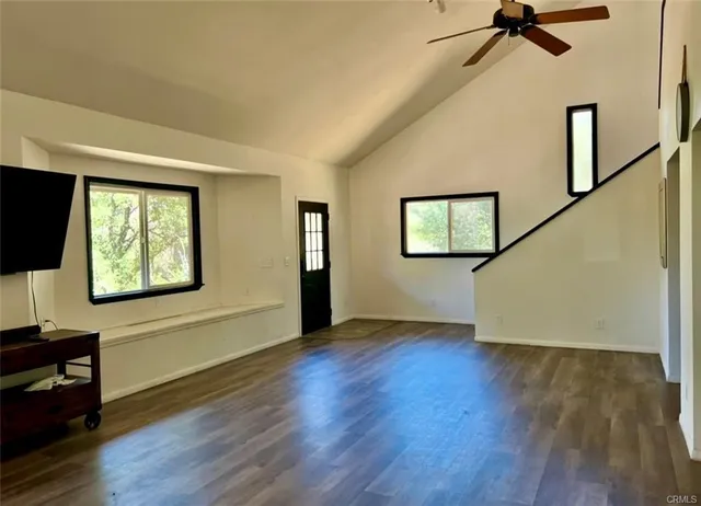 a view of a livingroom with wooden floor and a window