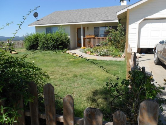 3260 West Ron Road, Unit 2 Paulden, AZ 86334 - Photo 1 of 17 a front view of a house with garden