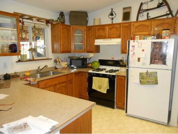 3260 West Ron Road, Unit 2 Paulden, AZ 86334 - Photo 4 of 17 a kitchen with a sink a stove and a refrigerator