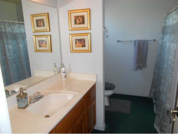 3260 West Ron Road, Unit 2 Paulden, AZ 86334 - Photo 10 of 17 a bathroom with a sink and mirror with toilet