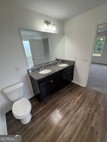 a spacious bathroom with a toilet sink and a mirror