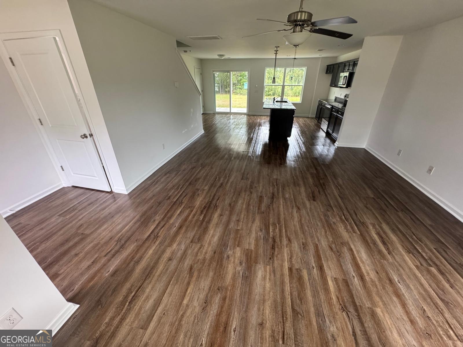 435 Wilkins Road Midway, GA 31320 - Photo 2 of 22 a view of an empty room with wooden floor and a window