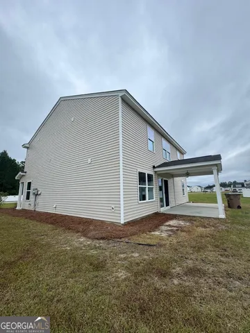 a view of a house with a backyard