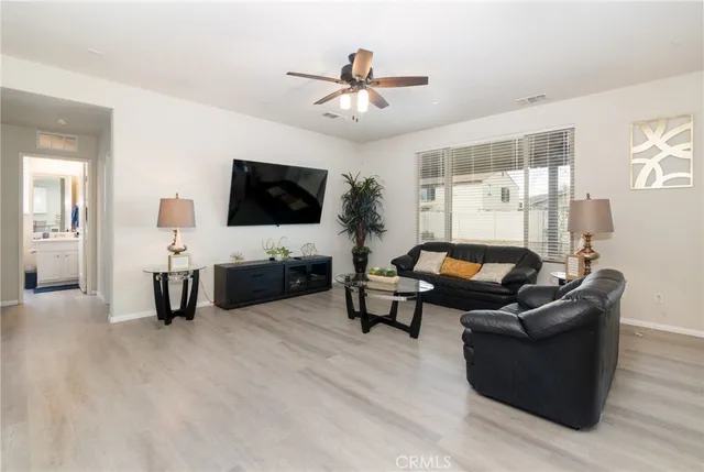 a living room with furniture and wooden floor