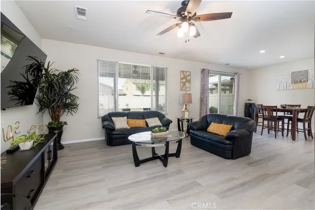 a living room with furniture and kitchen view