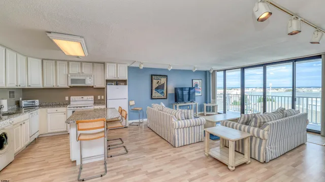 a living room with furniture large window and a flat screen tv